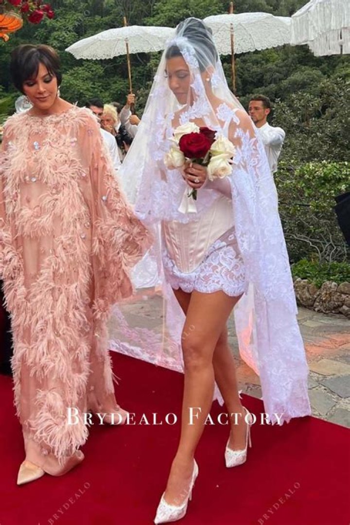 
Kourtney Kardashian Wears Short White Wedding Dress and Long Veil Inspired By Travis Barker’s Tattoo 